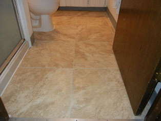 After - replaced subfloor, layed vinyl tile grouted with waterproof acrylic grout.